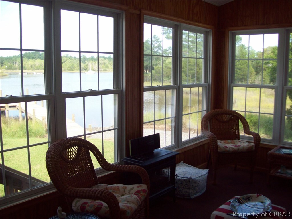 195 Hurst Neck Road Onemo, VA 23130 - Photo 12 of 30 a living room with furniture and a floor to ceiling window