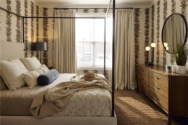 a bedroom with a bed a mirror and a window