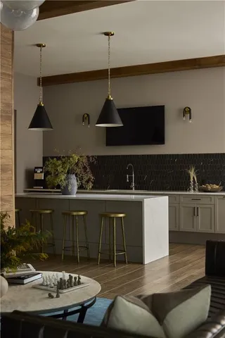 a kitchen with stainless steel appliances granite countertop a sink a stove and refrigerator