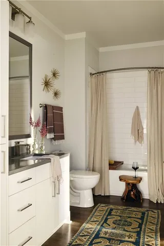 a bathroom with a sink toilet a mirror and shower