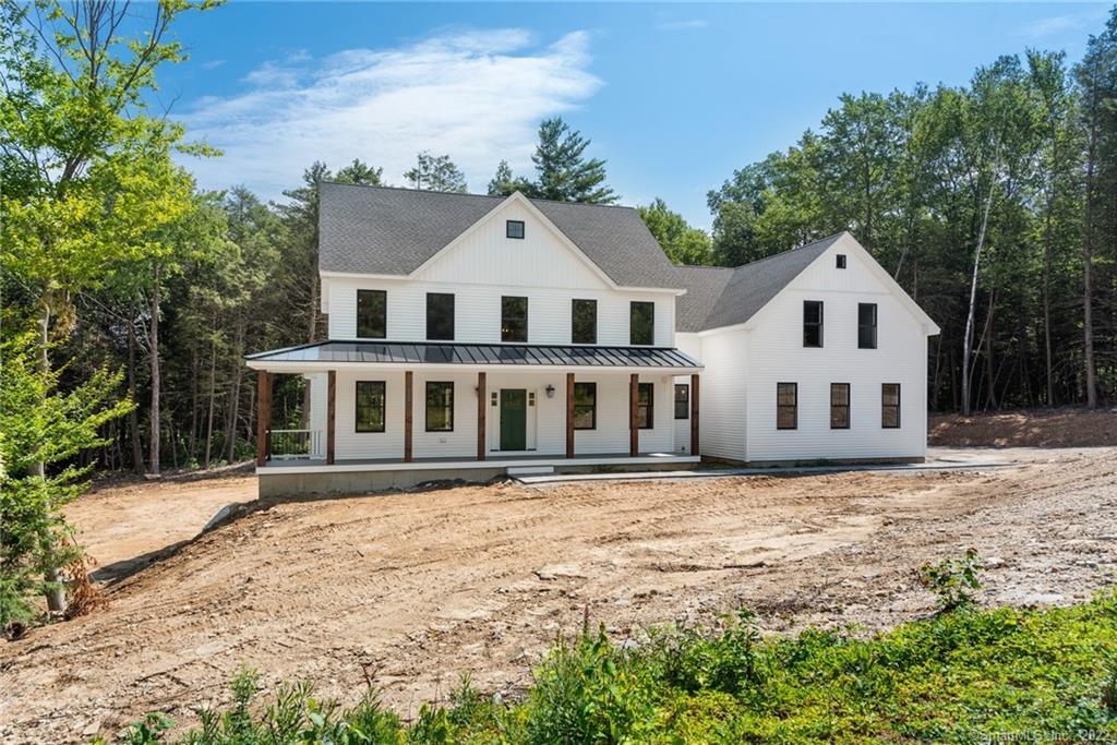 92 Gavitt Road, Unit 4 Barkhamsted, CT 06063 - Photo 1 of 1 a front view of a house with a garden