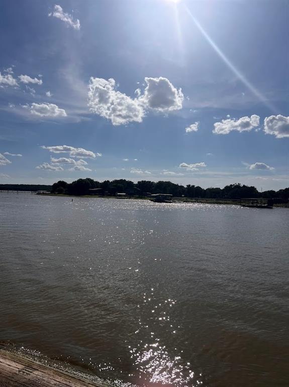 927 Cutter Circle May, TX 76857 - Photo 22 of 23 Waterfront setting featuring a distant treeline and buildings across the water