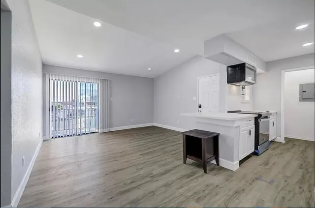 a view of a room with wooden floor and fireplace