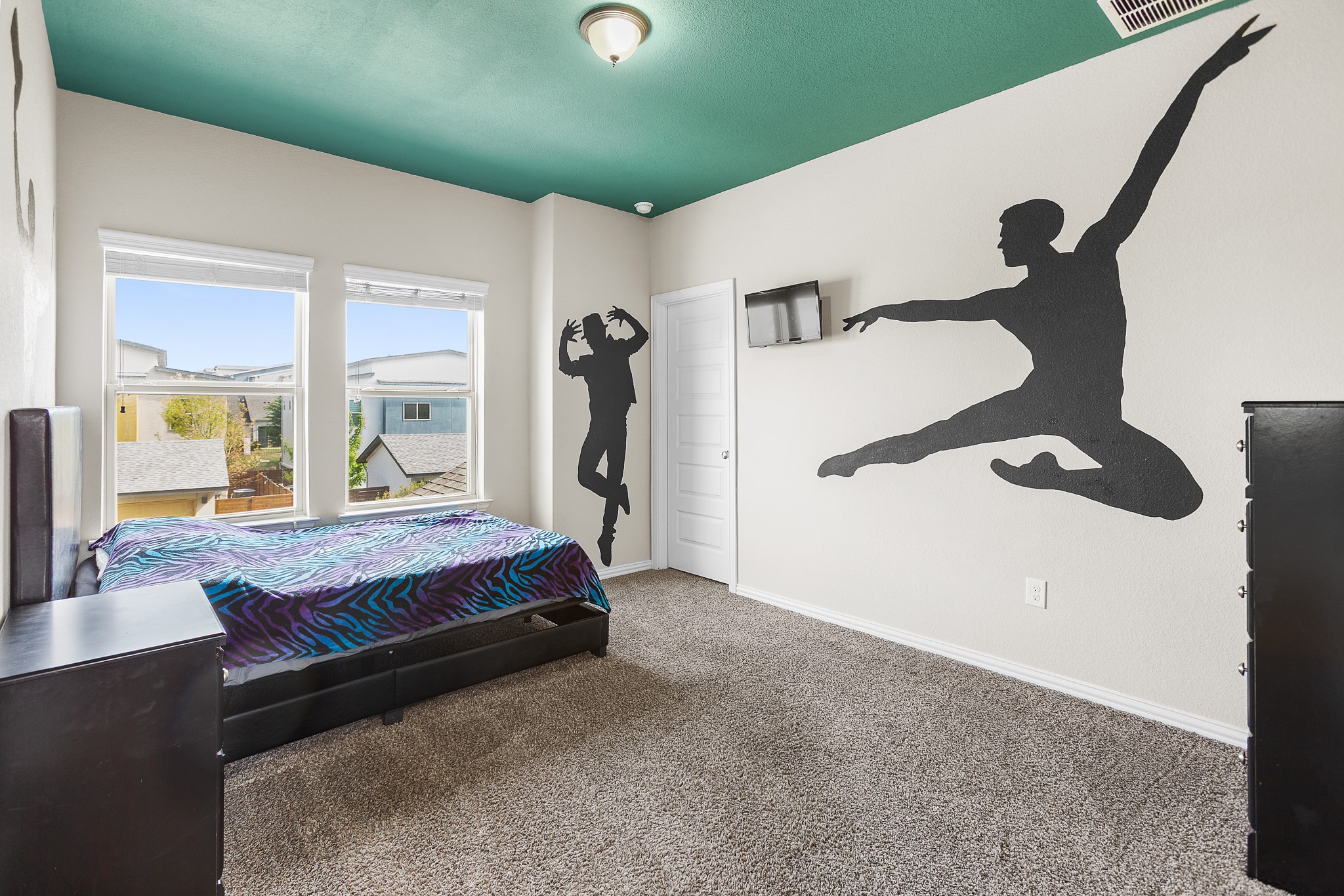 8709 Slater Drive Austin, TX 78747 - Photo 28 of 36 a bedroom with a bed and a large window