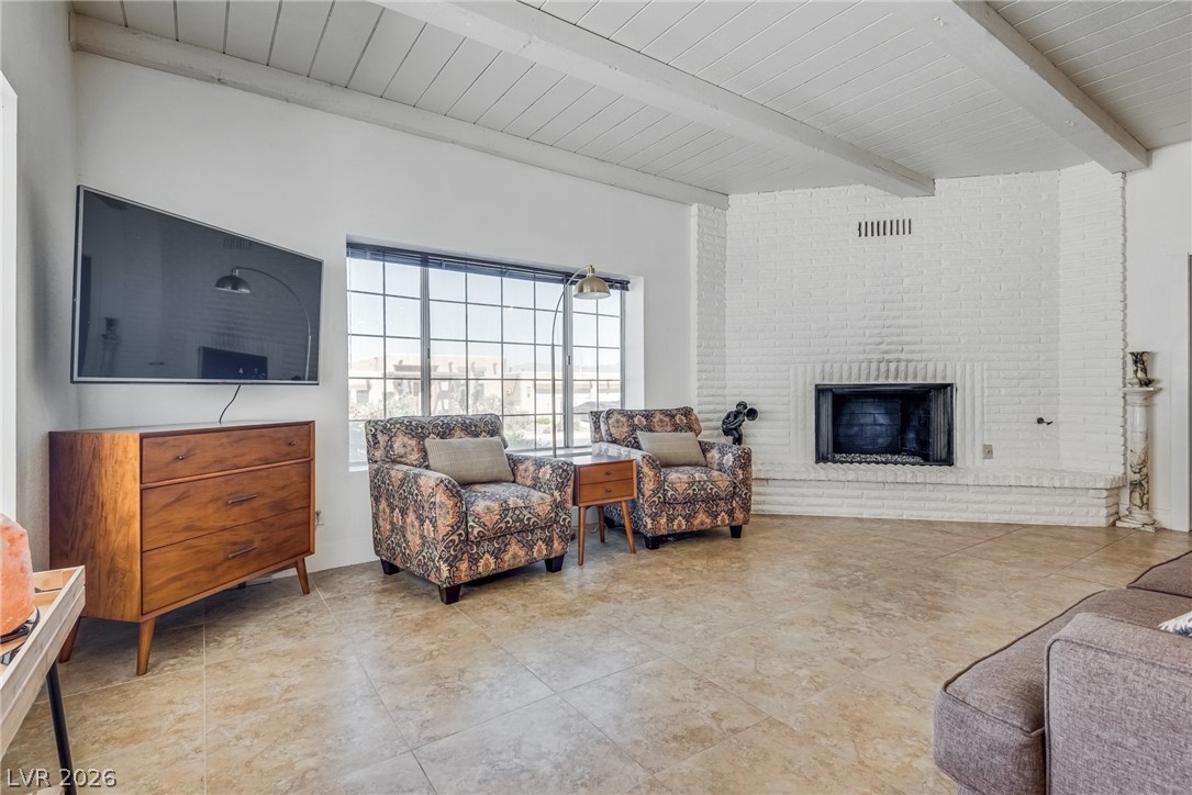 524 Swallow Cove Boulder City, NV 89005 - Photo 8 of 58 A spacious living area offers a warm fireplace, abundant natural light, and tile flooring throughout.