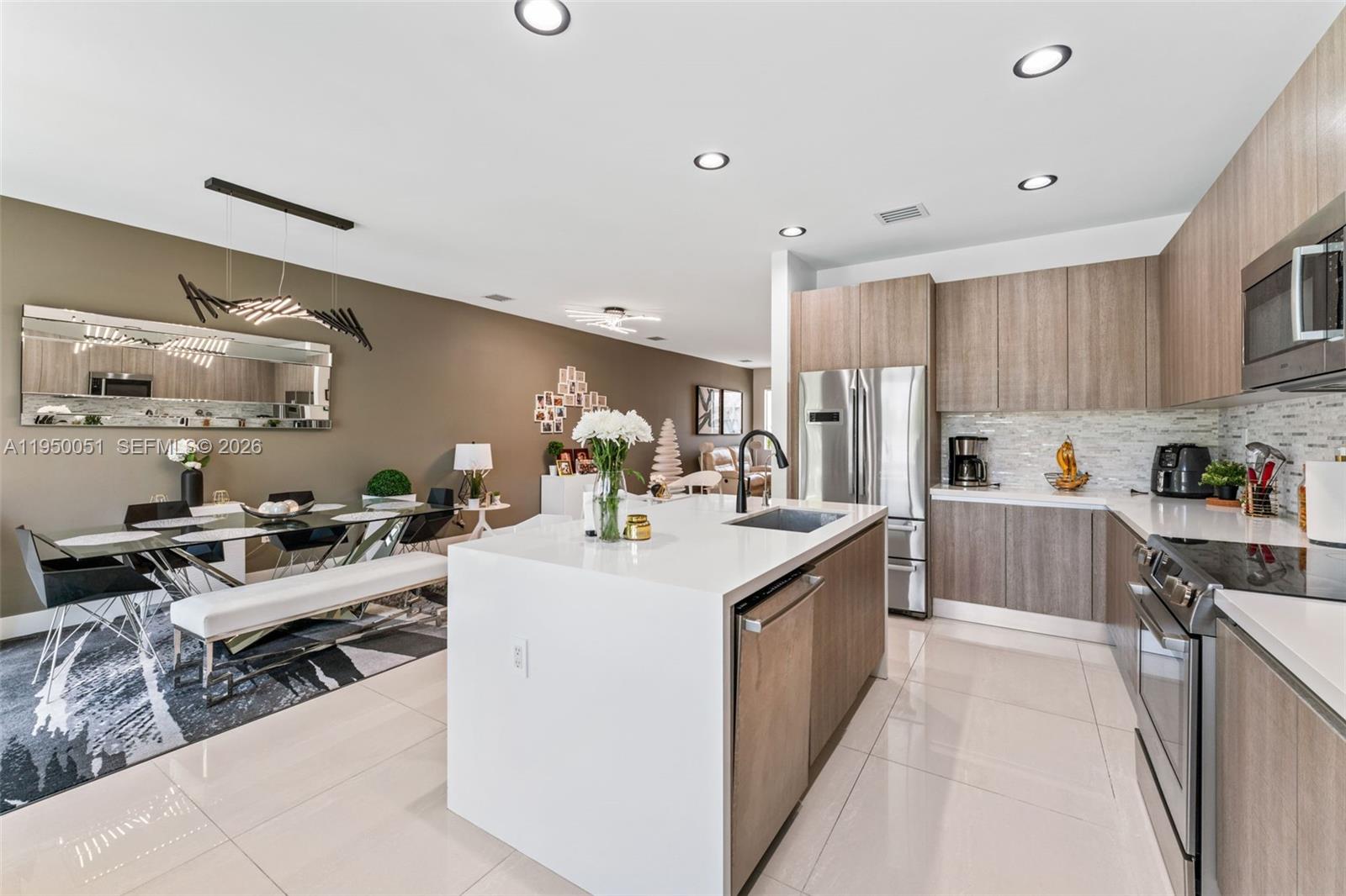 7226 Northwest 103rd Path Doral, FL 33178 - Photo 11 of 38 a kitchen with stainless steel appliances kitchen island granite countertop a sink and cabinets