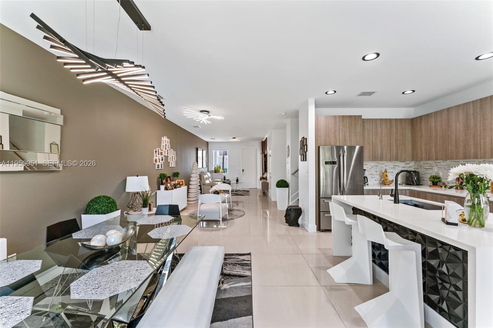 7226 Northwest 103rd Path Doral, FL 33178 - Photo 12 of 38 a living room with stainless steel appliances furniture a rug and a kitchen view