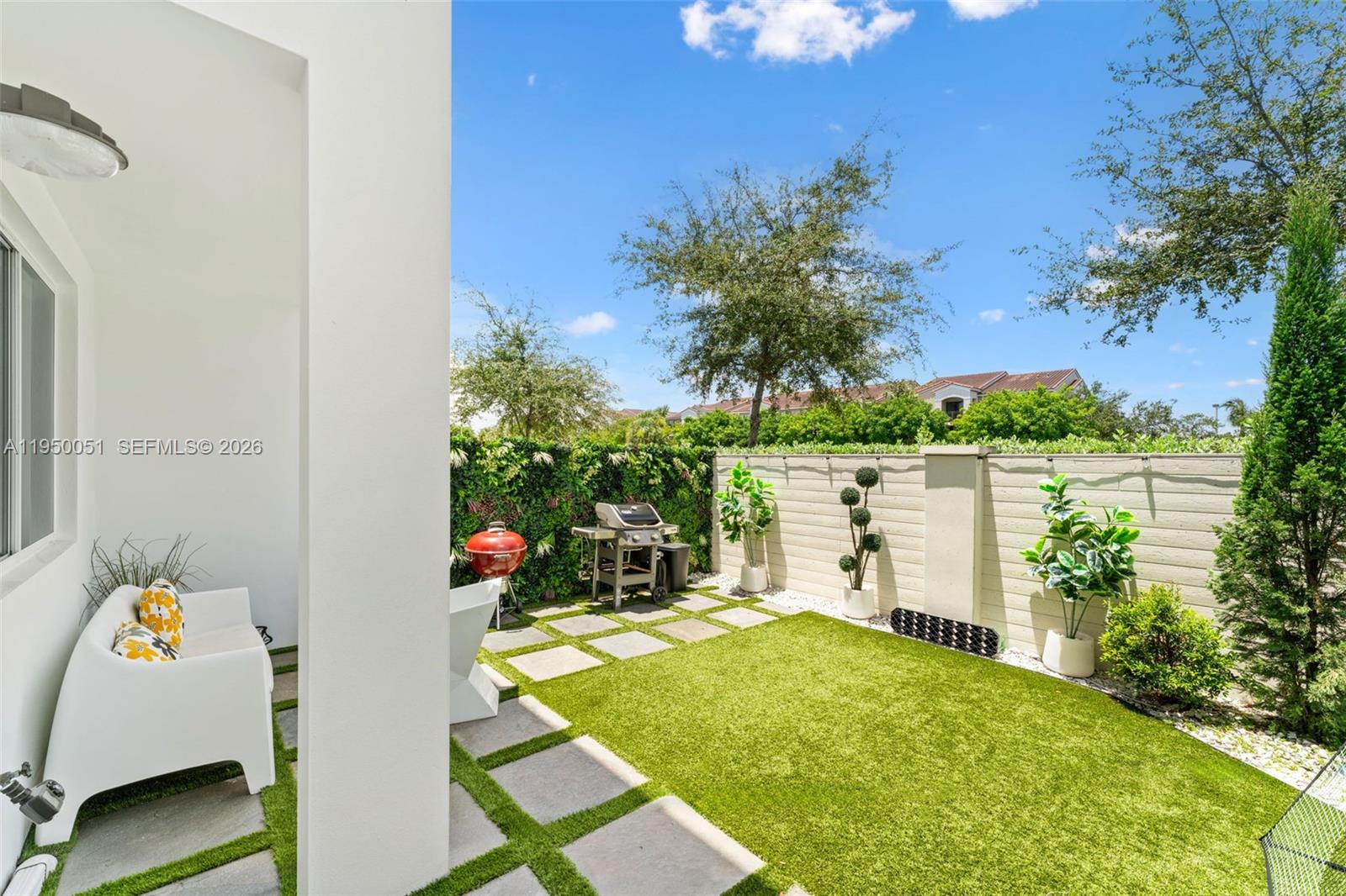 7226 Northwest 103rd Path Doral, FL 33178 - Photo 14 of 38 a backyard of a house with outdoor seating