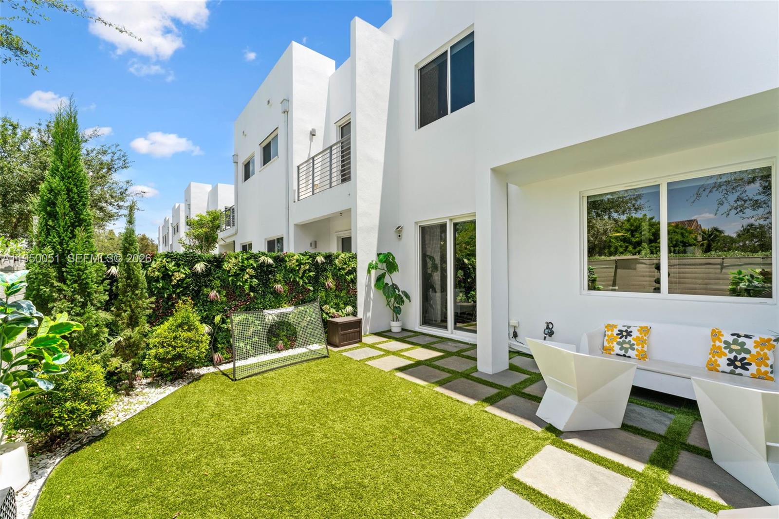 7226 Northwest 103rd Path Doral, FL 33178 - Photo 16 of 38 a view of a patio with couches table and chairs and potted plants