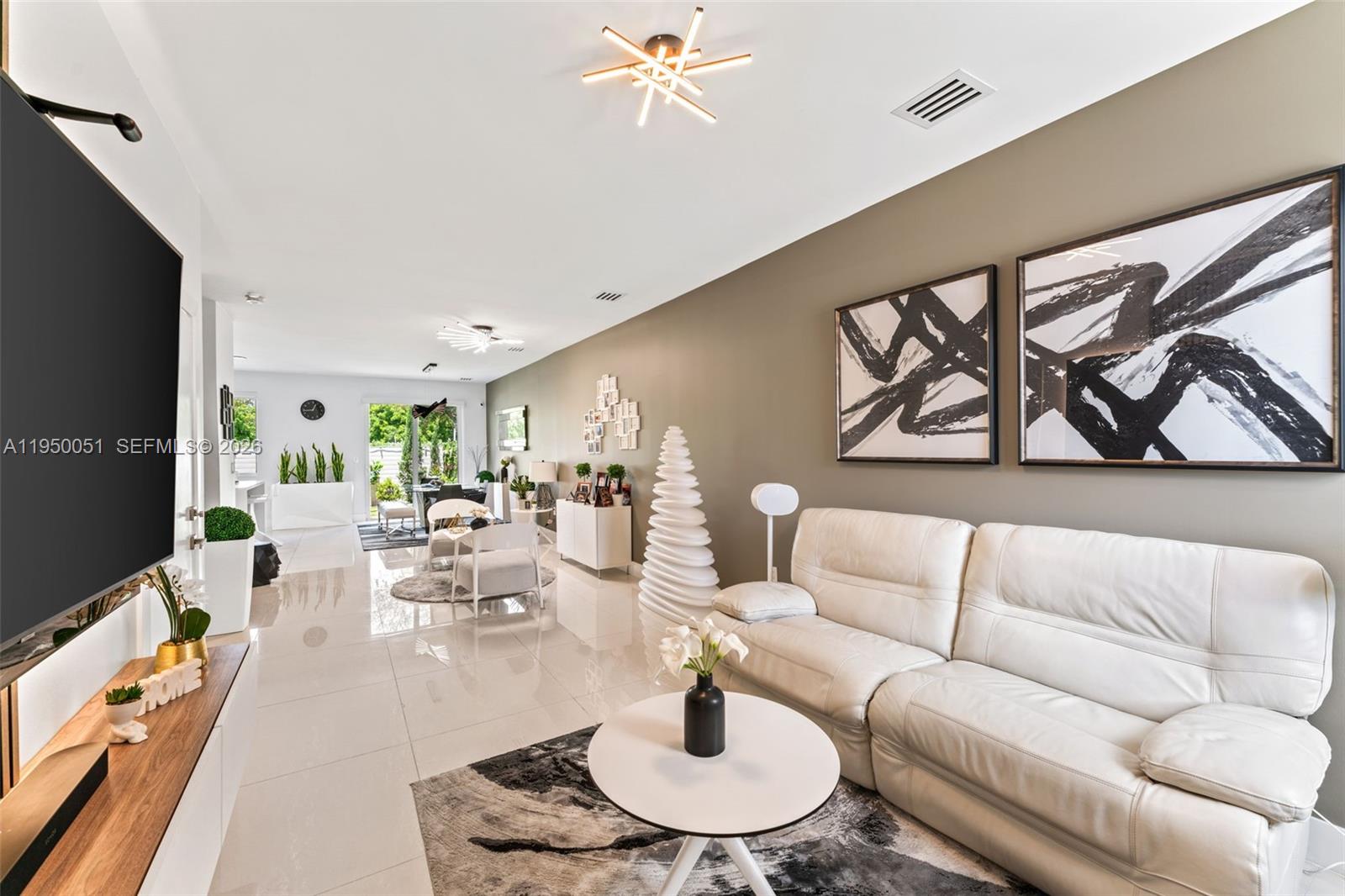 7226 Northwest 103rd Path Doral, FL 33178 - Photo 2 of 38 a living room with furniture and a flat screen tv
