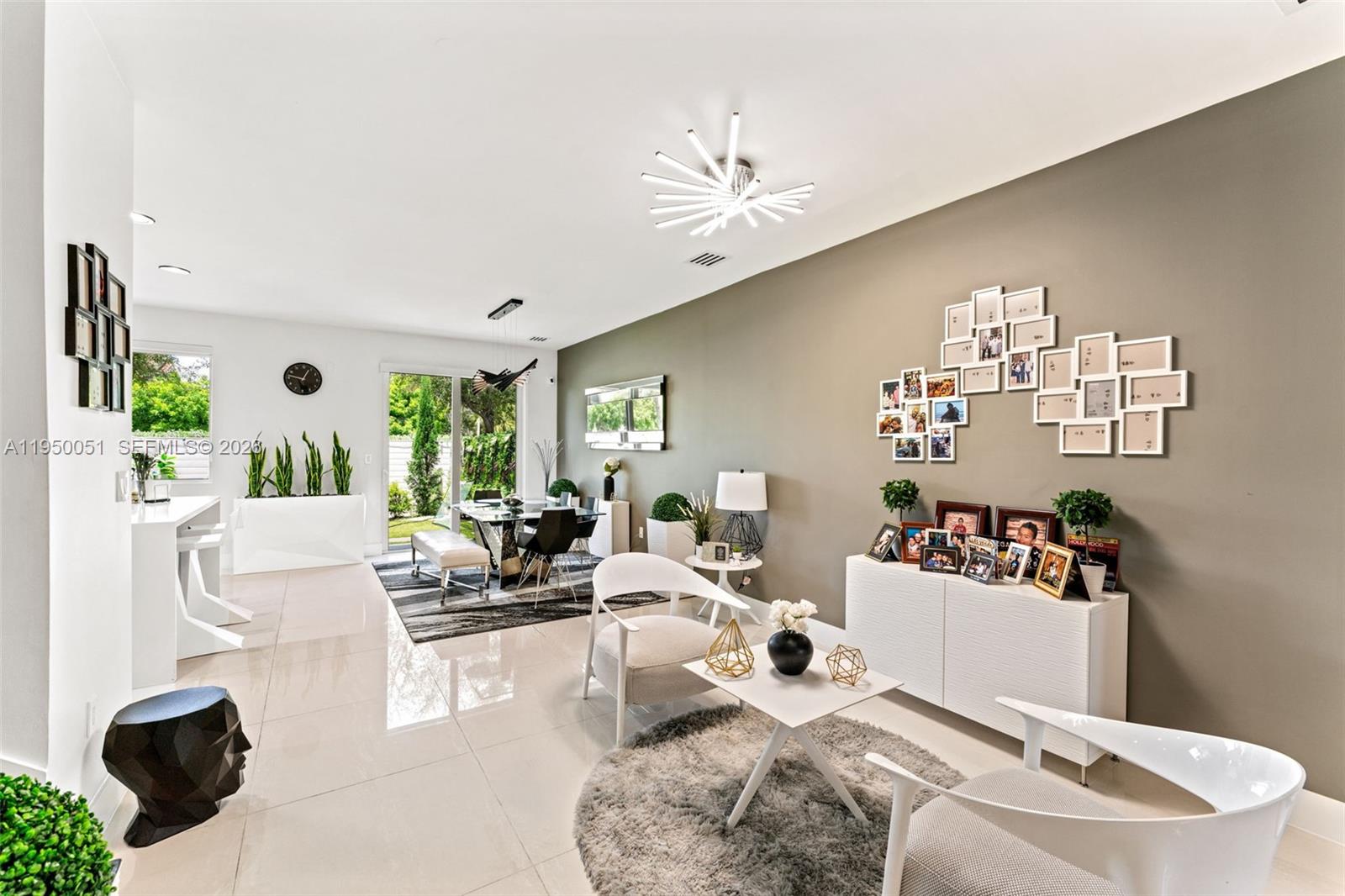 7226 Northwest 103rd Path Doral, FL 33178 - Photo 5 of 38 a living room with furniture and a chandelier