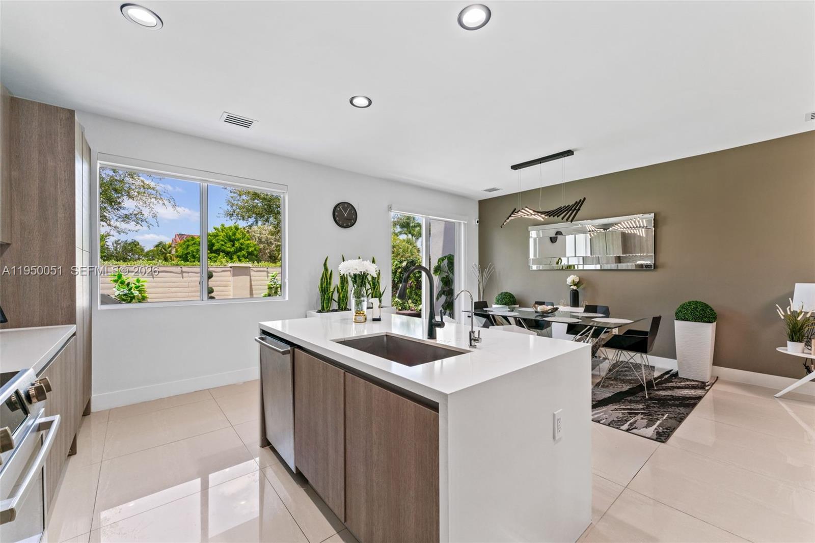 7226 Northwest 103rd Path Doral, FL 33178 - Photo 10 of 38 a room with furniture a large window and a flat screen tv