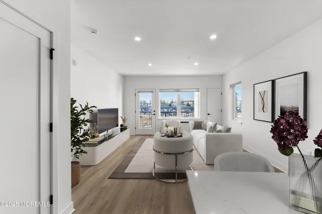 a living room with furniture a chandelier and a potted plant