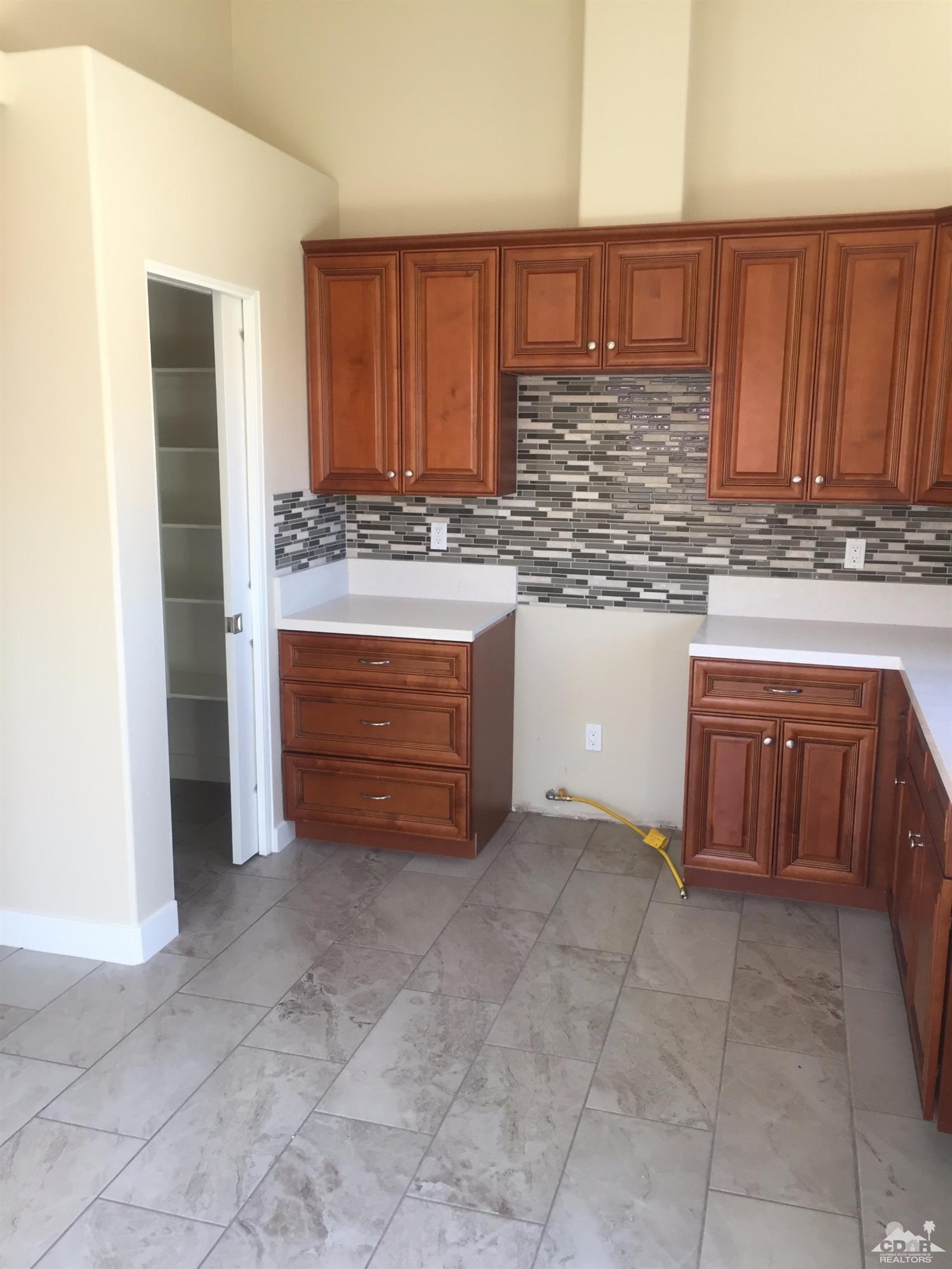 13689 Ocotillo Road Desert Hot Springs, CA 92240 - Photo 2 of 9 a kitchen with stainless steel appliances granite countertop a stove and a sink