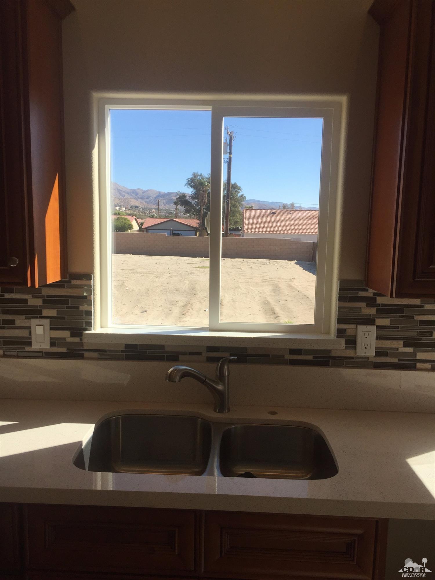 13689 Ocotillo Road Desert Hot Springs, CA 92240 - Photo 3 of 9 a kitchen sink sitting next to a window