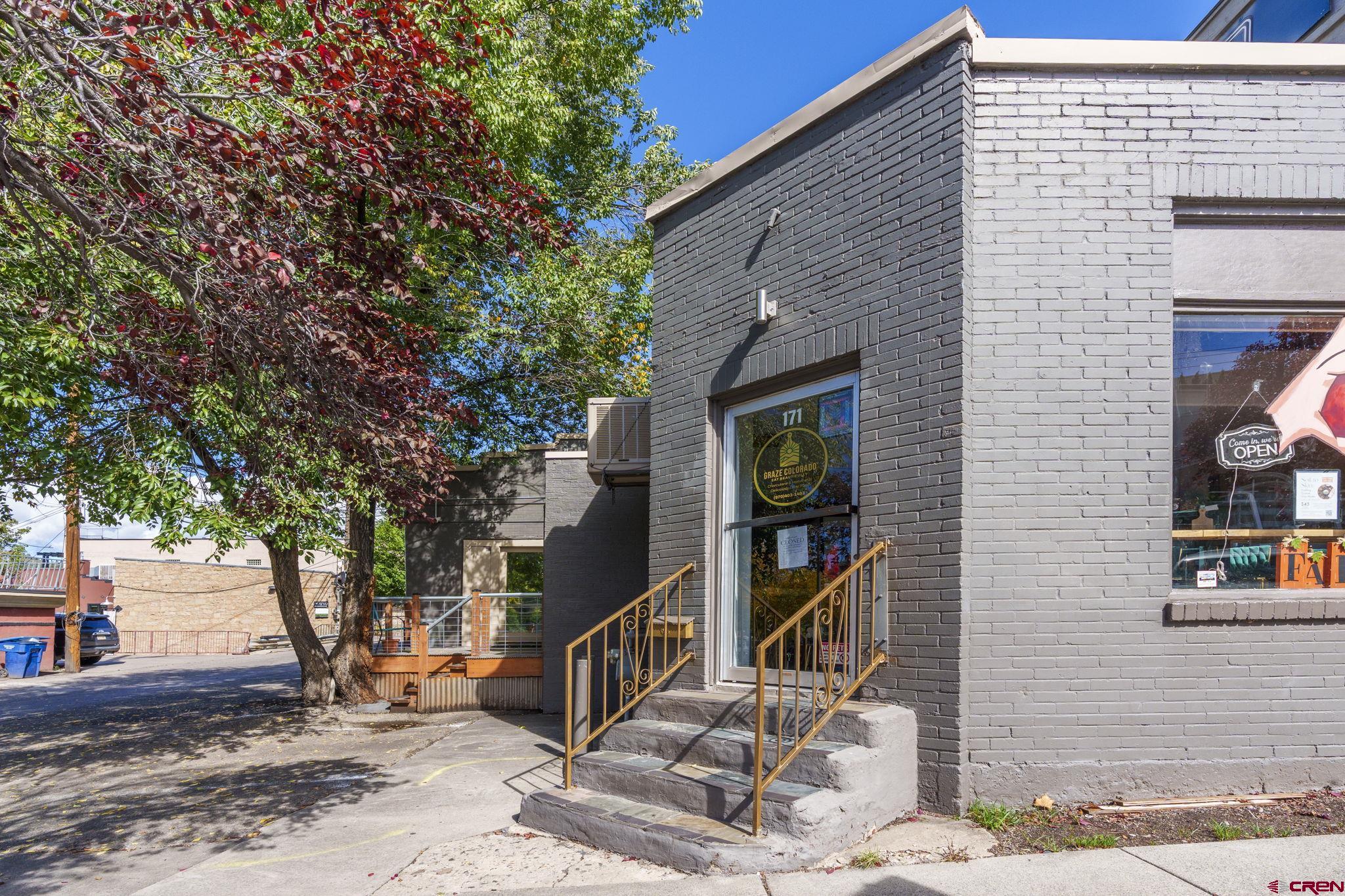 a front view of a house with stairs