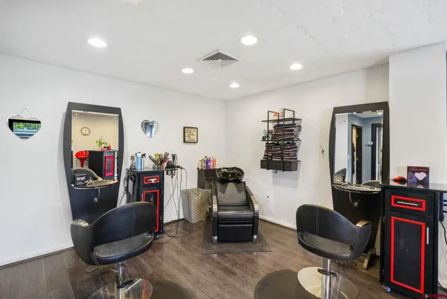 a living room with furniture and a mirror