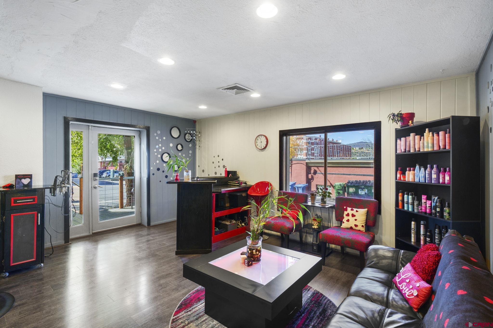 171 East 7th Street Durango, CO 81301 - Photo 15 of 36 a living room with furniture a bookshelf and a large window