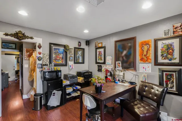 a view of a livingroom with furniture and a workspace