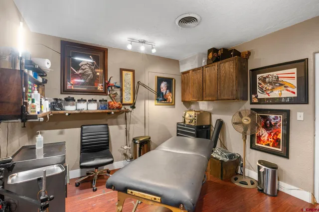 a view of a workspace with furniture and window