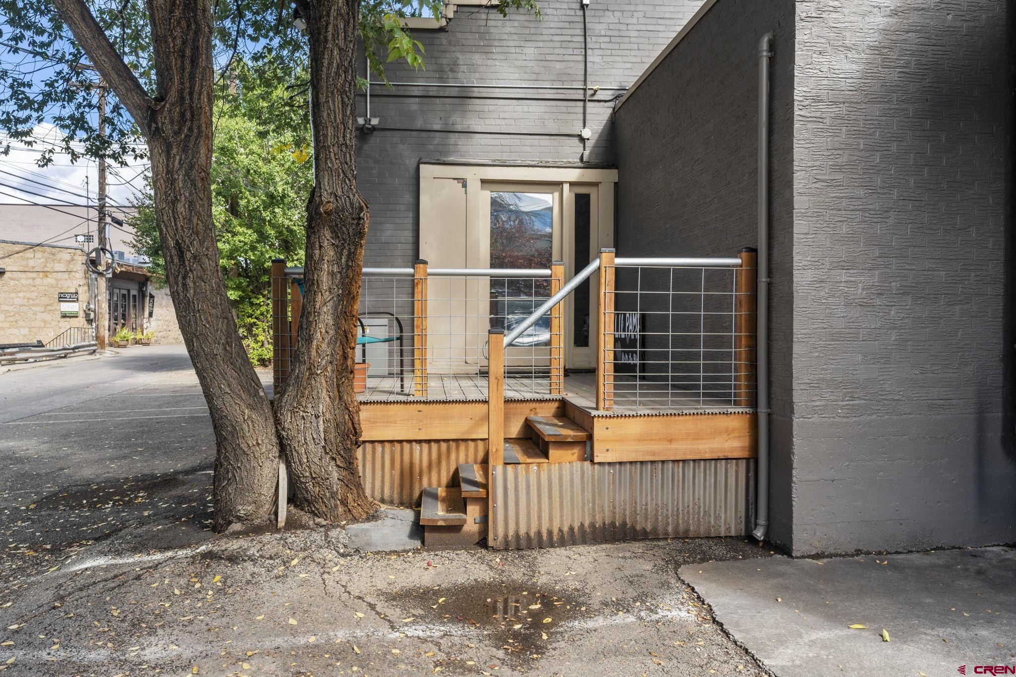 171 East 7th Street Durango, CO 81301 - Photo 4 of 36 a view of a house with a tree and wooden fence