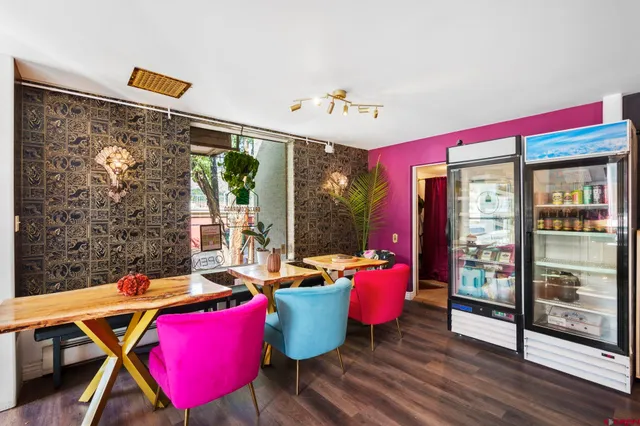 a room with gym equipment wooden floor and window
