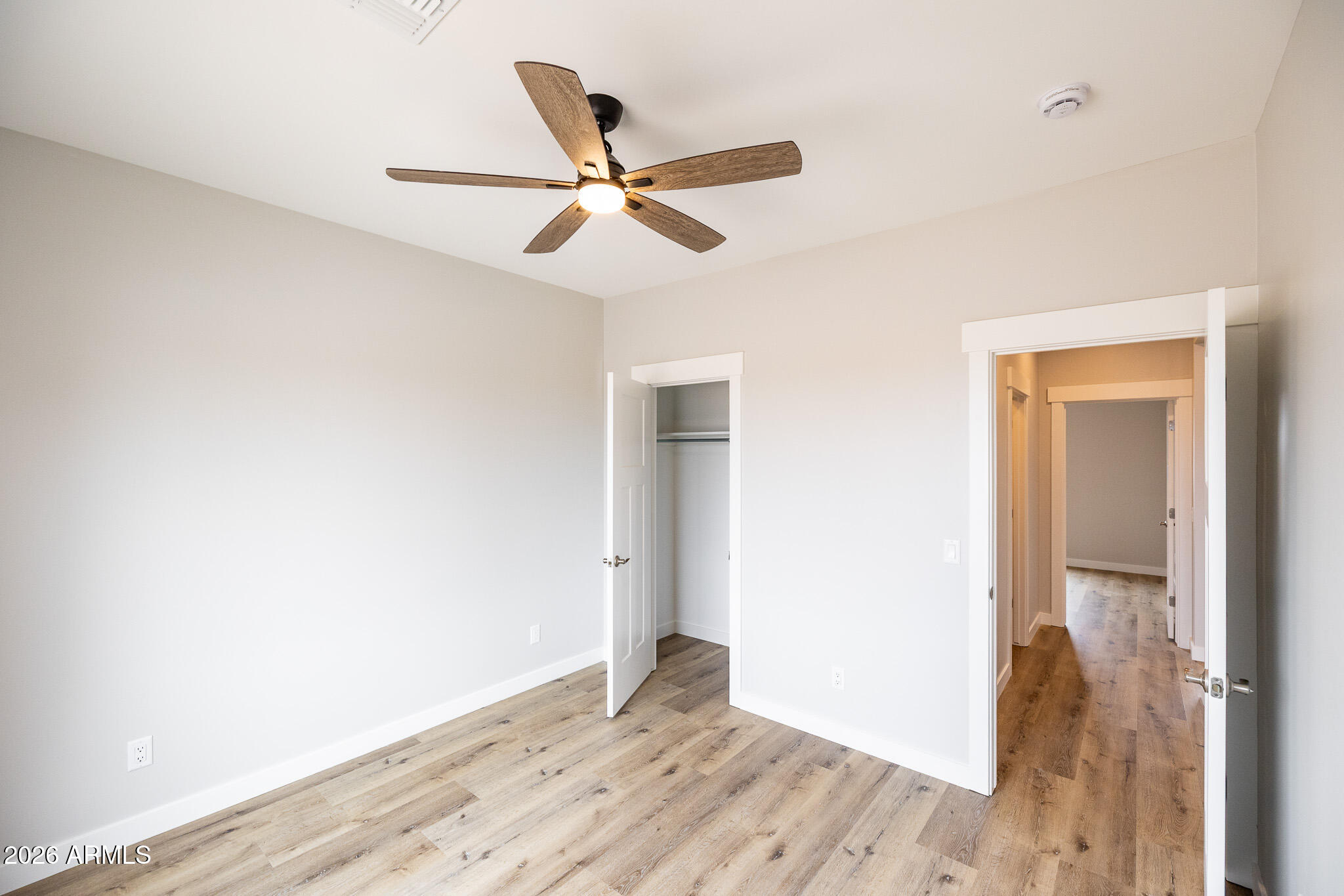 11459 East Adamsville Road Florence, AZ 85132 - Photo 23 of 63 a view of empty room with wooden floor and fan