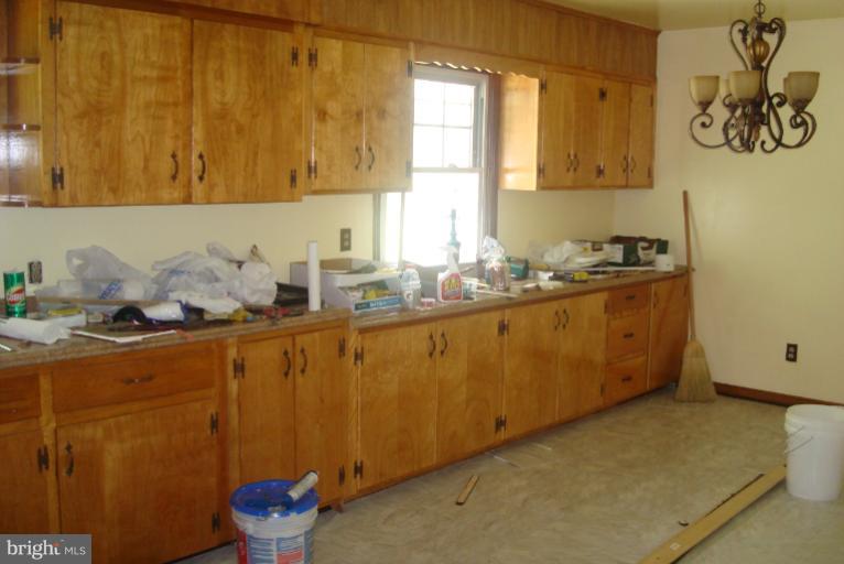 9001 Marye Road Partlow, VA 22534 - Photo 13 of 25 a kitchen with a sink a stove and cabinets