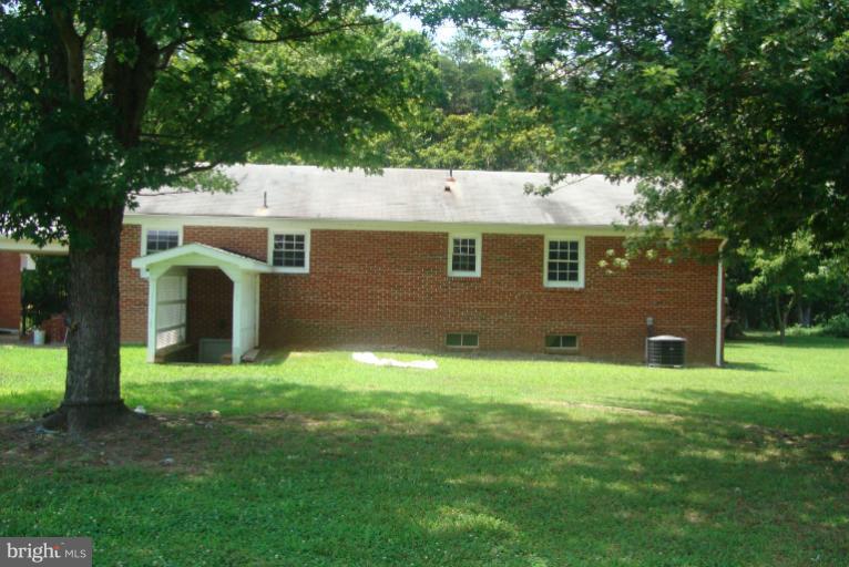 9001 Marye Road Partlow, VA 22534 - Photo 17 of 25 a backyard of a house with large trees and plants