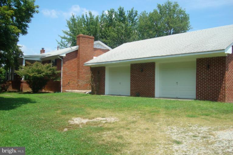 9001 Marye Road Partlow, VA 22534 - Photo 23 of 25 a backyard of a house with plants and large tree