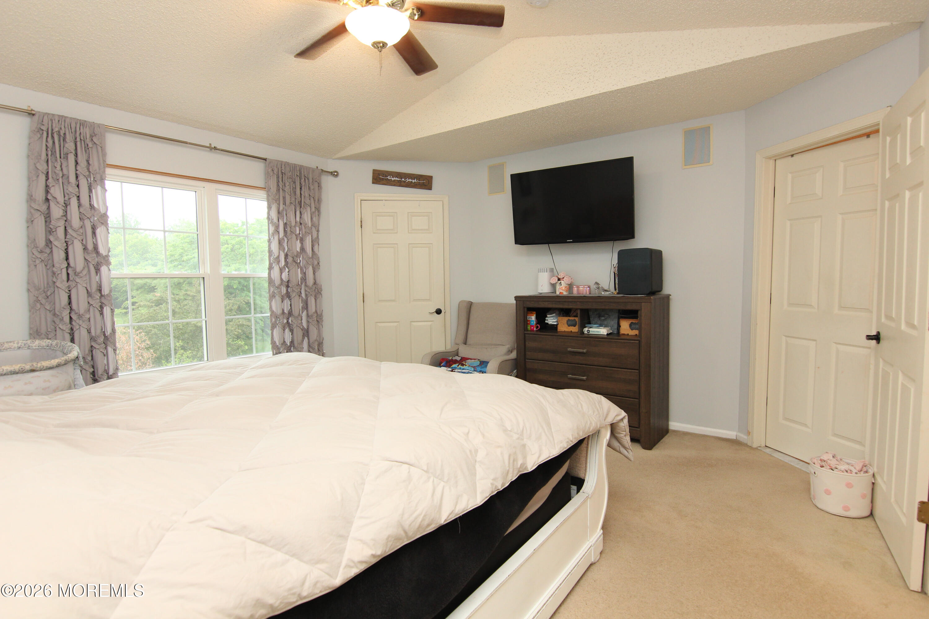 33 Austin Street Tinton Falls, NJ 07712 - Photo 3 of 46 a bedroom with a bed and a flat screen tv