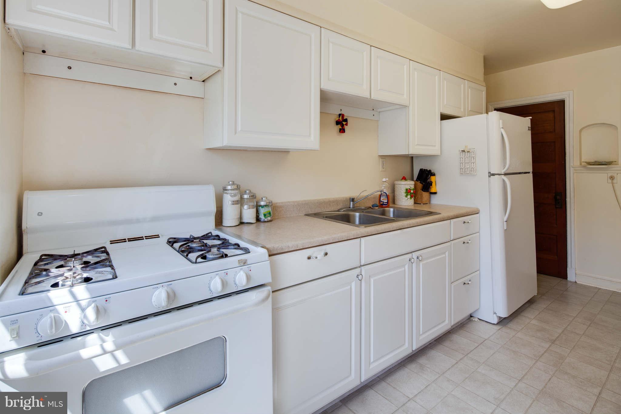 342 Greenlow Road Baltimore, MD 21228 - Photo 3 of 28 a kitchen with white cabinets and white appliances