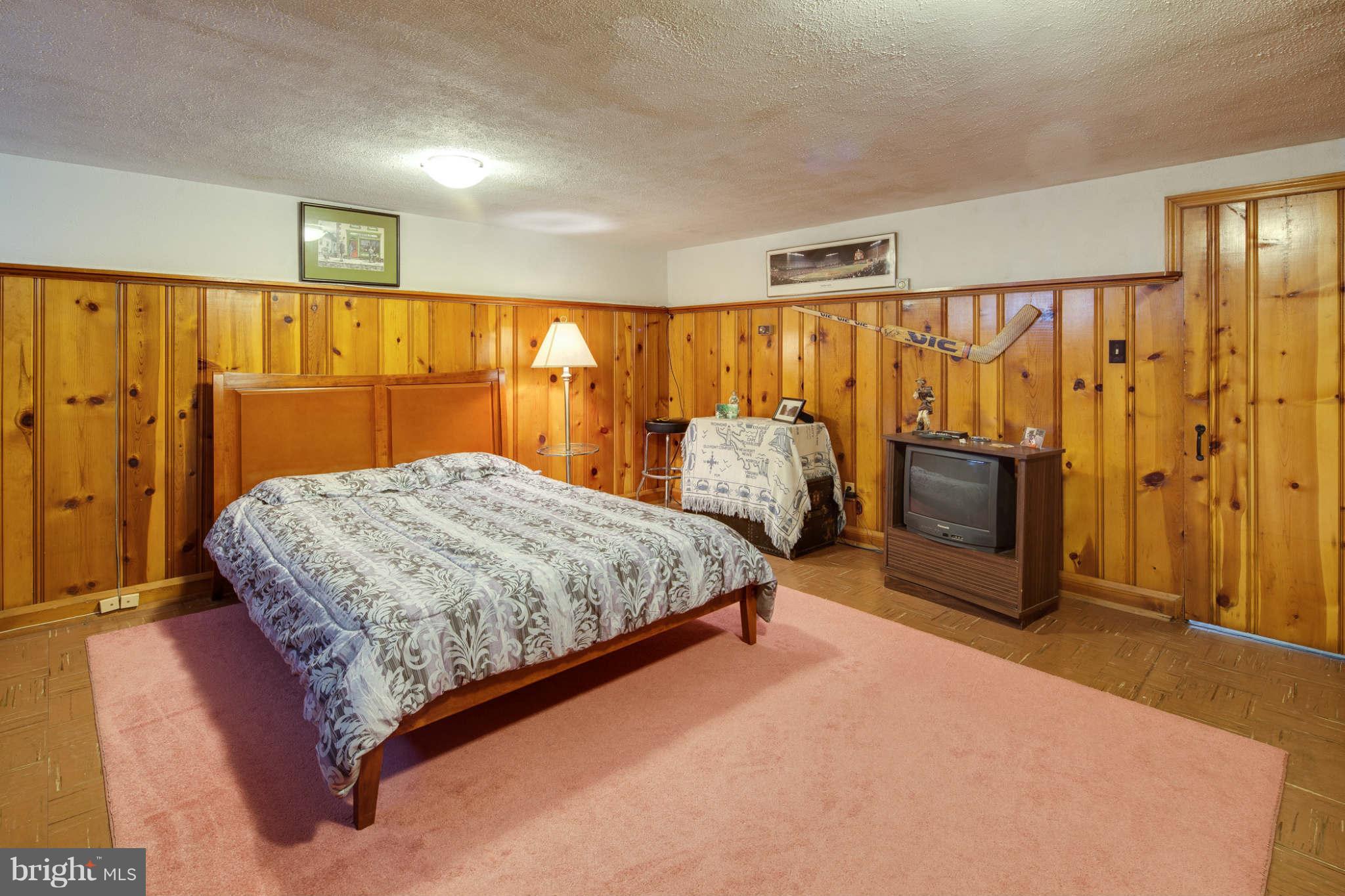 342 Greenlow Road Baltimore, MD 21228 - Photo 24 of 28 a bedroom with a bed and wooden floor