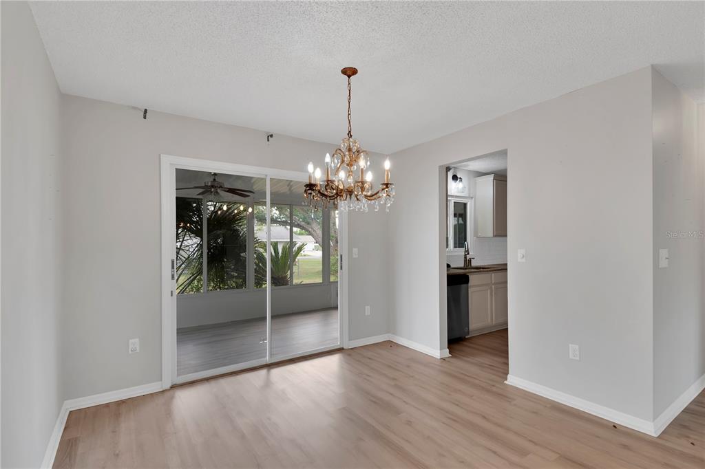 6366 Southwest 115th Street Road Ocala, FL 34476 - Photo 13 of 45 a view of a chandelier in an empty room with a window