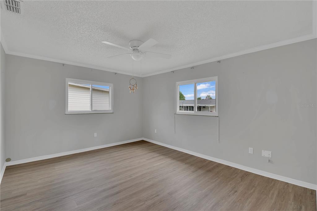 6366 Southwest 115th Street Road Ocala, FL 34476 - Photo 14 of 45 a view of an empty room with wooden floor and a window