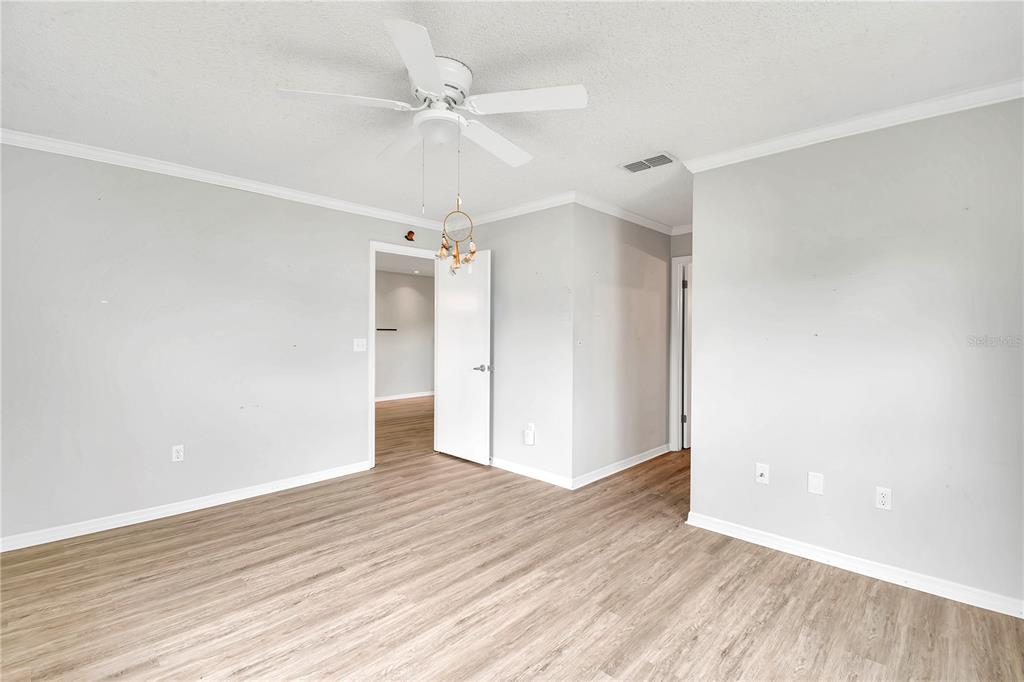 6366 Southwest 115th Street Road Ocala, FL 34476 - Photo 15 of 45 wooden floor in an empty room with a fan
