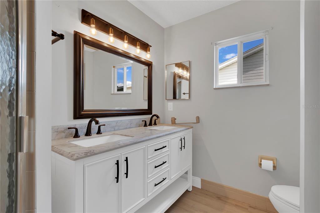 6366 Southwest 115th Street Road Ocala, FL 34476 - Photo 17 of 45 a bathroom with a toilet sink and mirror