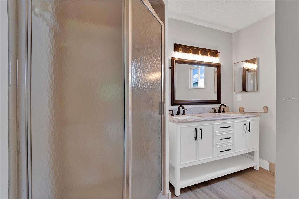 6366 Southwest 115th Street Road Ocala, FL 34476 - Photo 18 of 45 a bathroom with a double vanity sink and mirror