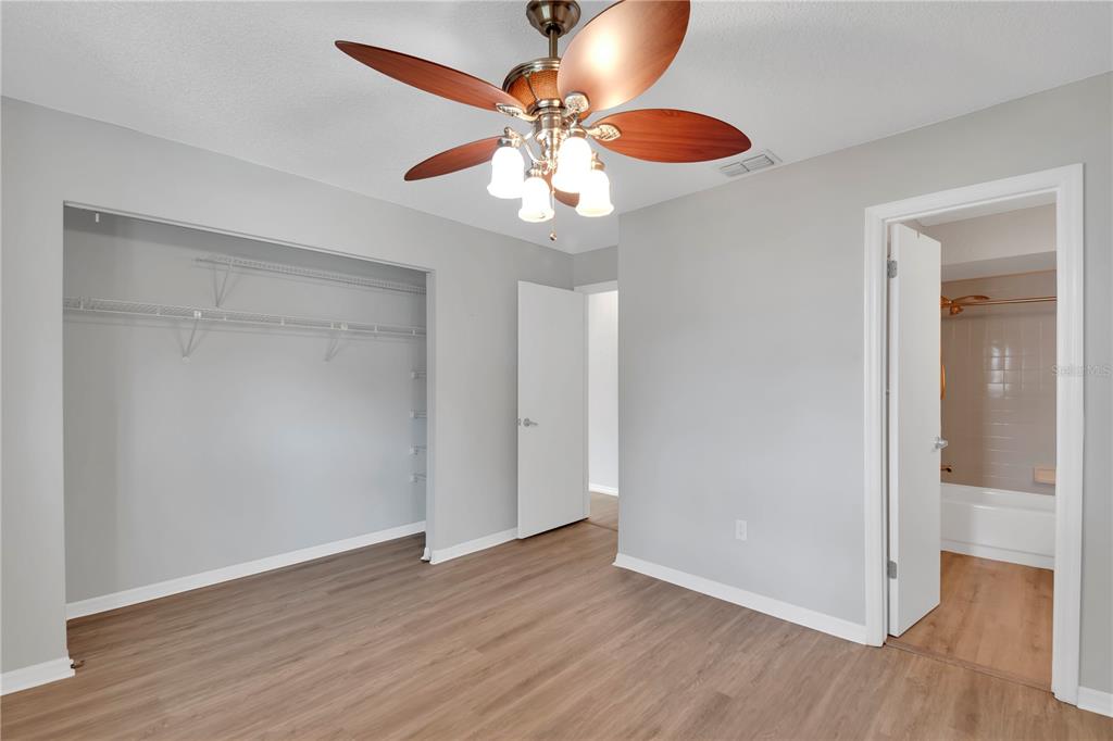 6366 Southwest 115th Street Road Ocala, FL 34476 - Photo 20 of 45 a view of an empty room with wooden floor