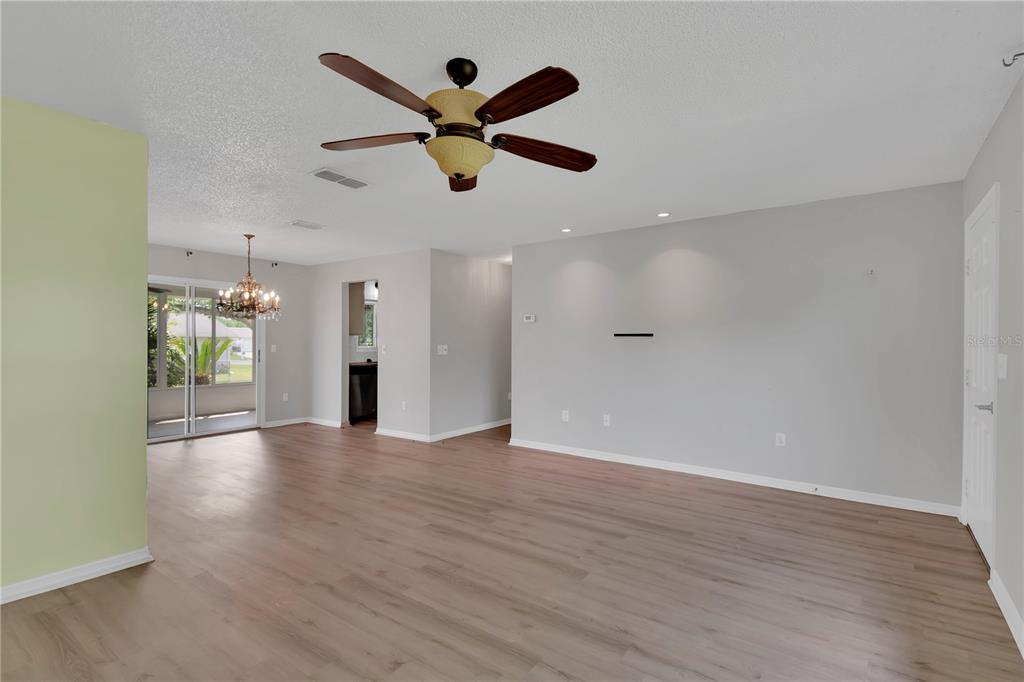 6366 Southwest 115th Street Road Ocala, FL 34476 - Photo 8 of 45 an empty room with wooden floor and windows