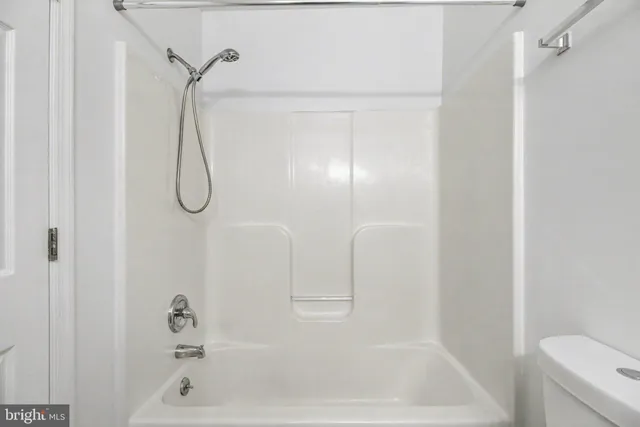 a bathroom with a bath tub with a shower
