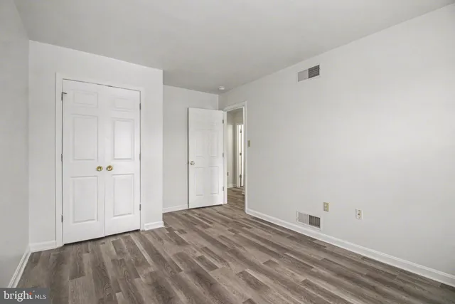 a view of a room with wooden floor and closet