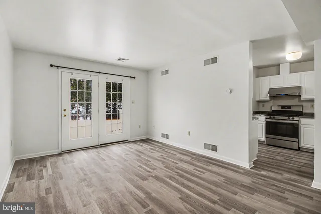 a view of kitchen with wooden floor electronic appliances and window