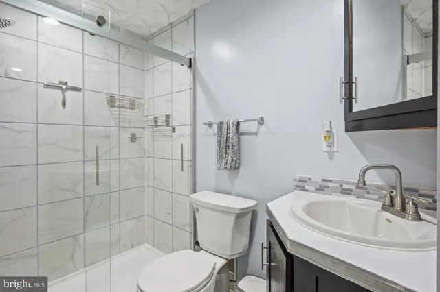 a bathroom with a sink a mirror and a shower