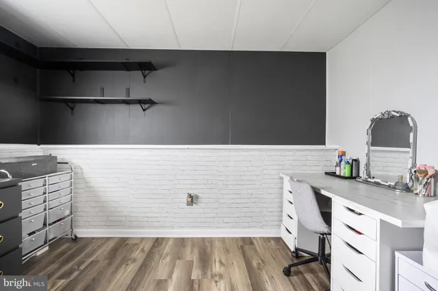 a kitchen with stainless steel appliances granite countertop a sink a stove and a wooden cabinets