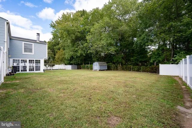 a view of a house with a yard porch and sitting area