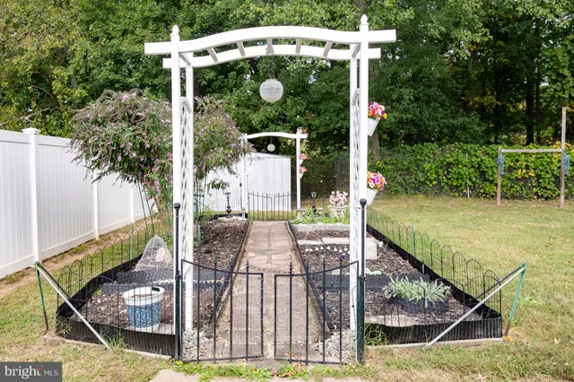 a view of backyard with a barn and large trees
