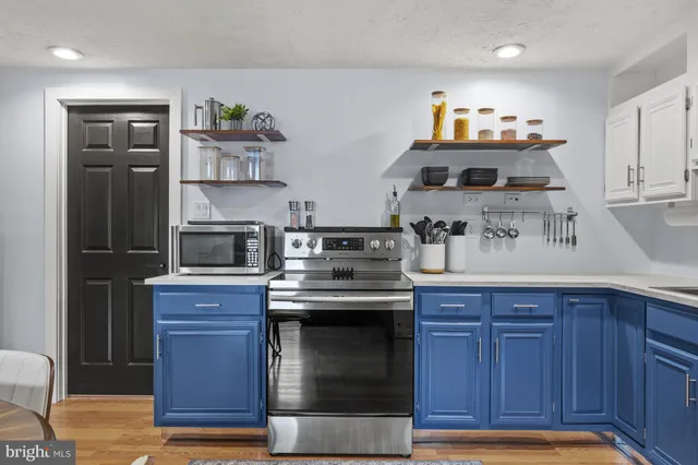 a kitchen with stainless steel appliances granite countertop a stove and a refrigerator