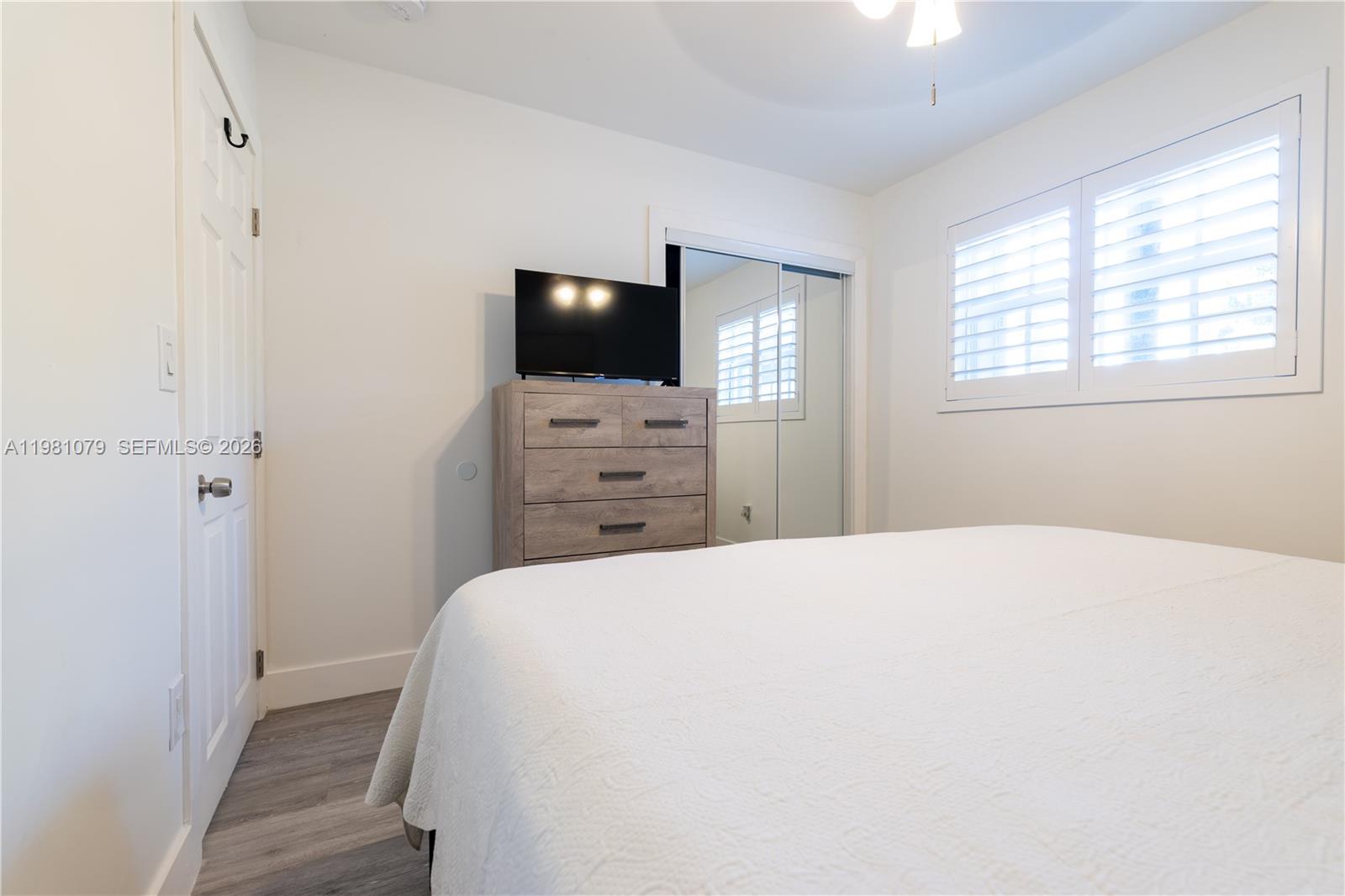 19600 Gulfstream Road Cutler Bay, FL 33157 - Photo 12 of 36 a bedroom with a bed and a flat screen tv