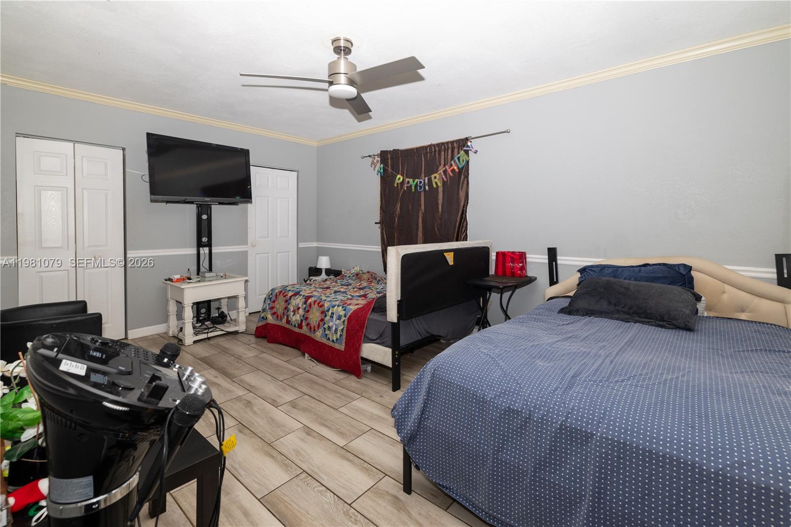 19600 Gulfstream Road Cutler Bay, FL 33157 - Photo 17 of 36 a bedroom with a bed and a flat screen tv